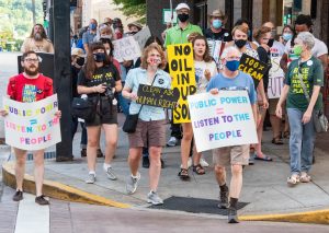 Marchers cross a street on Gay Street behind HBG Chair Jerry Thornton